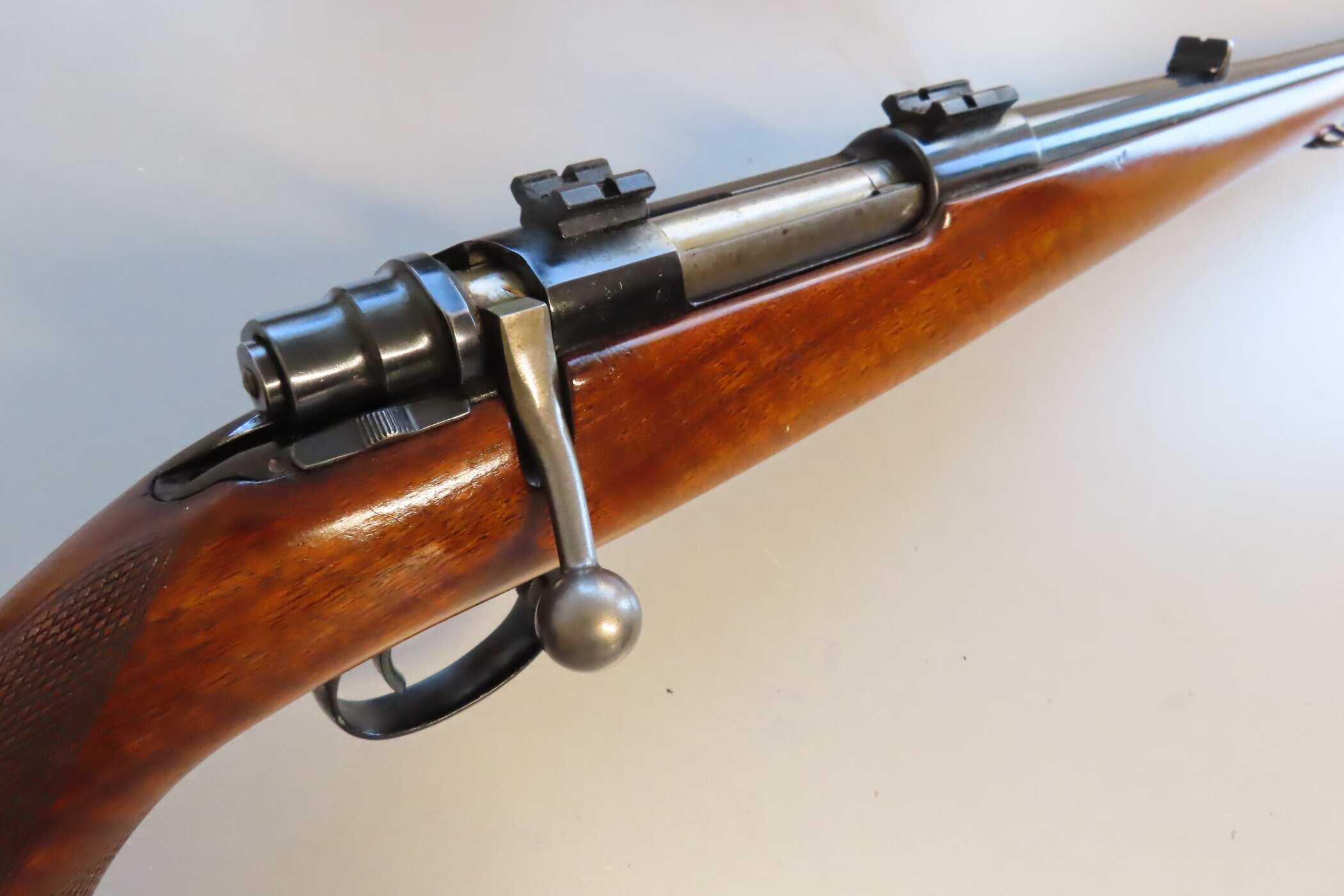 Vintage bolt-action rifle with wooden stock and metal components, part of Colonial Ammunition Company's collection.
