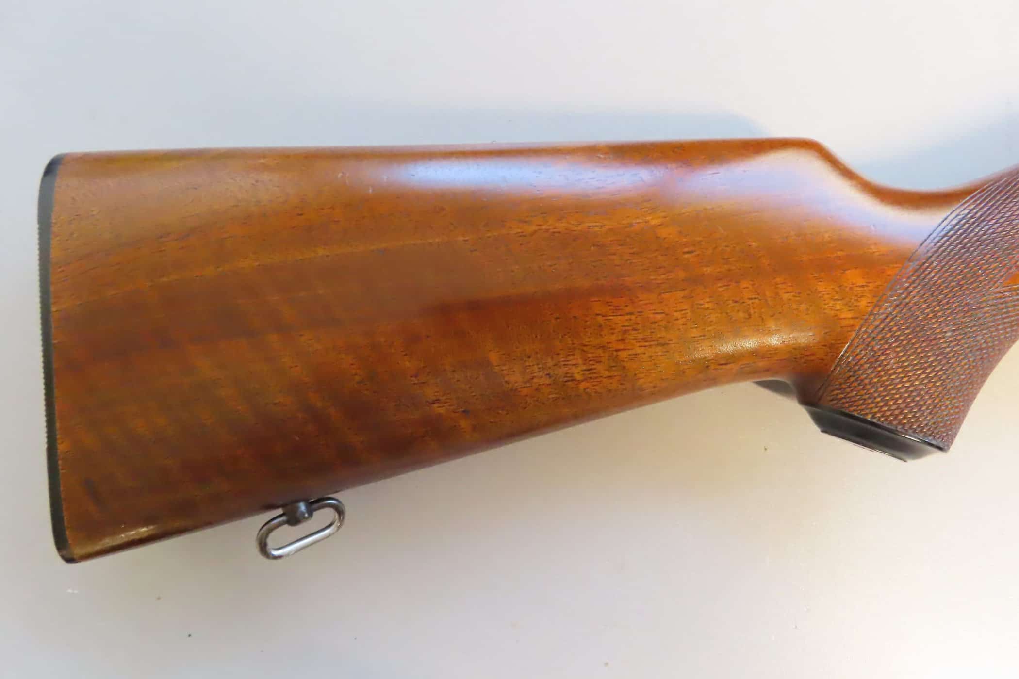 Antique rifle stock showcasing polished wood and fine craftsmanship, ideal for firearm collectors and enthusiasts.