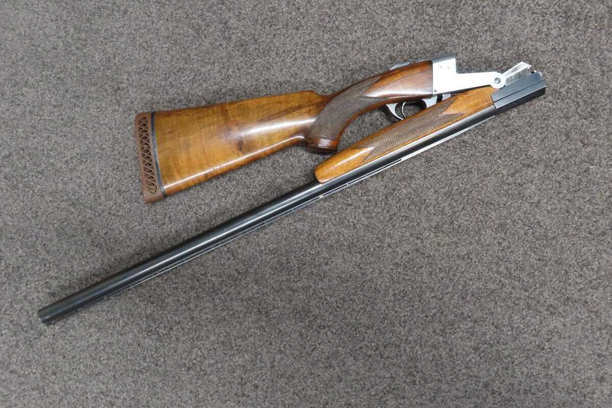 Traditional hunting firearm with wooden stock and metal barrel for shooting sports.