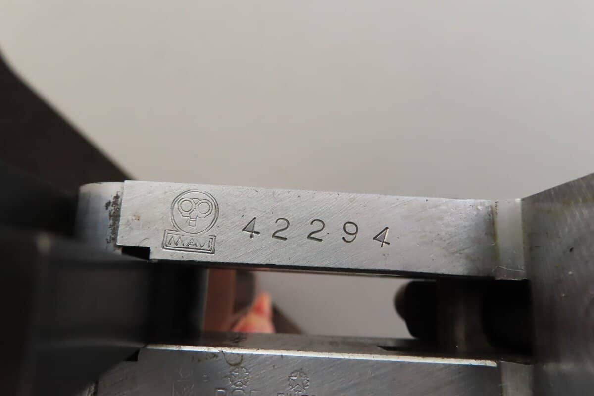 Highly detailed image of a vintage ammunition serial number and logo at Colonial Ammunition Company.