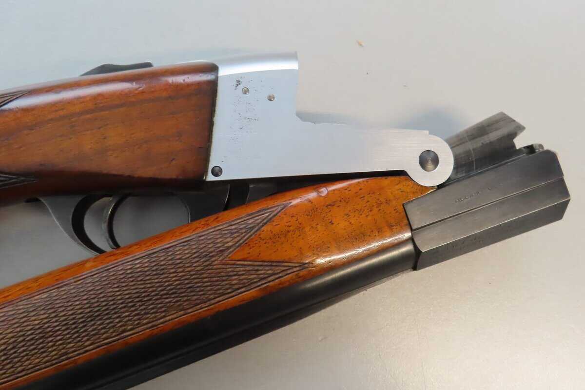 Detailed image of a vintage firearm featuring wooden stock and metal components.