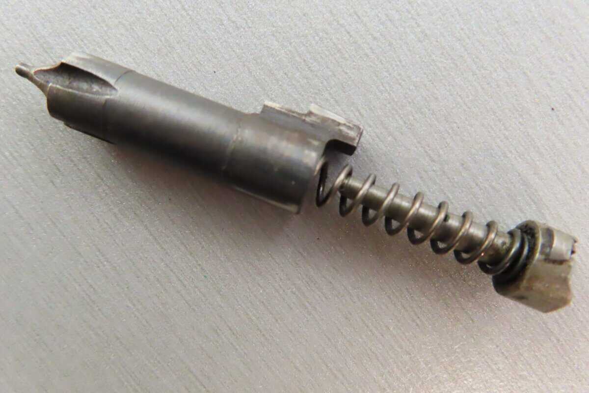 Close-up of a metallic firing pin and spring used in vintage firearm ammunition at Colonial Ammunition Company.