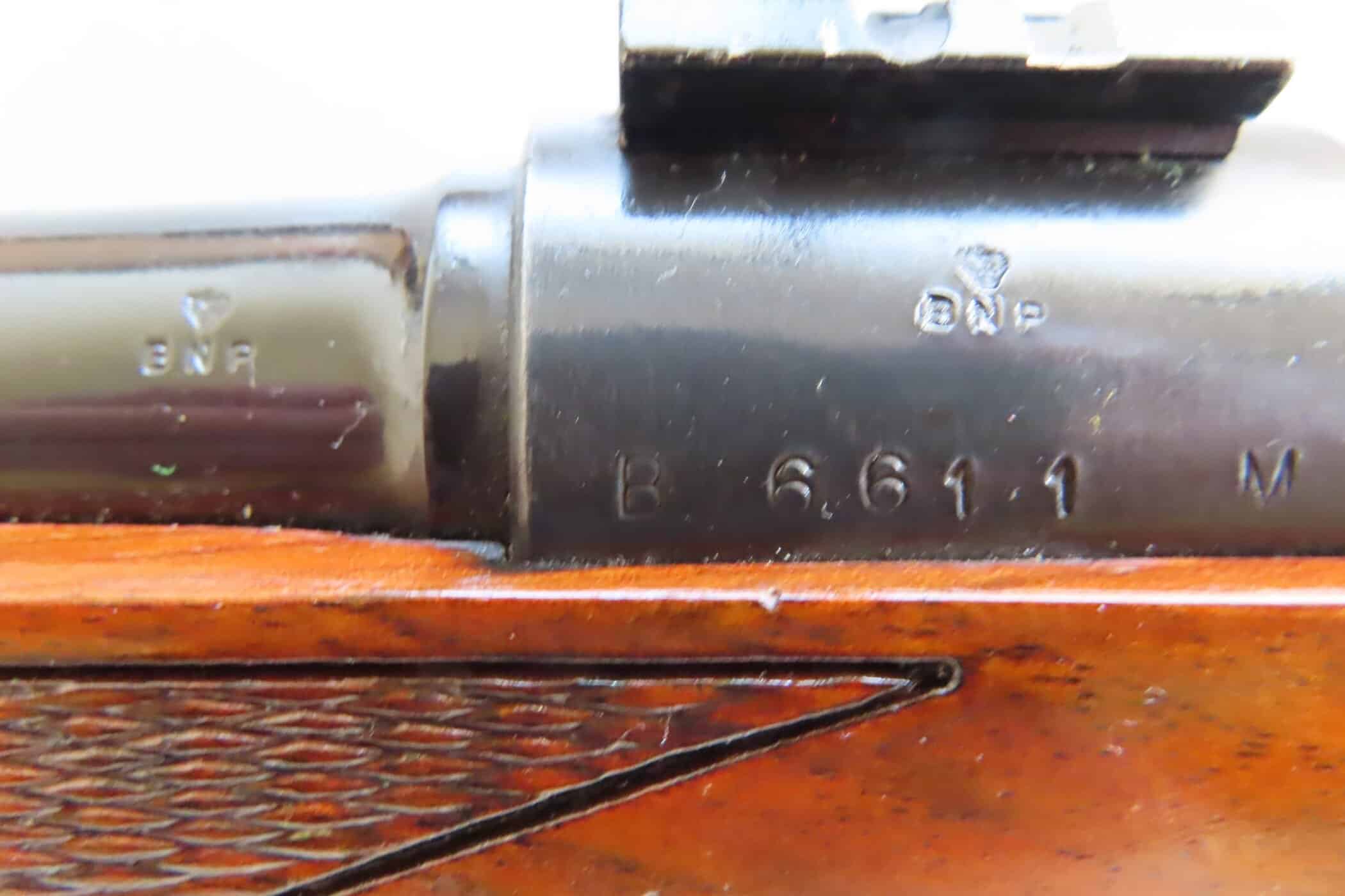Antique firearm serial number etched on metal, highlighting historical firearm markings and craftsmanship.