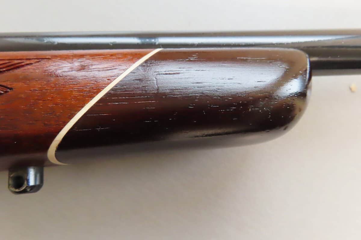 Vintage rifle stock close-up with polished wooden finish and rubber recoil pad, showcasing expertise in firearm accessories at Colonial Ammunition Company NZ.