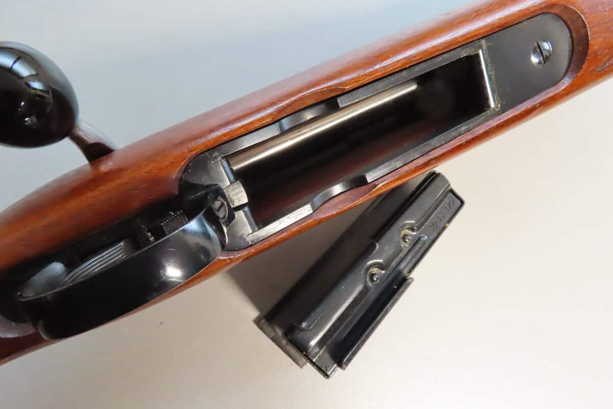 Close-up of bolt action on vintage rifle, showcasing classic firearm design and craftsmanship.