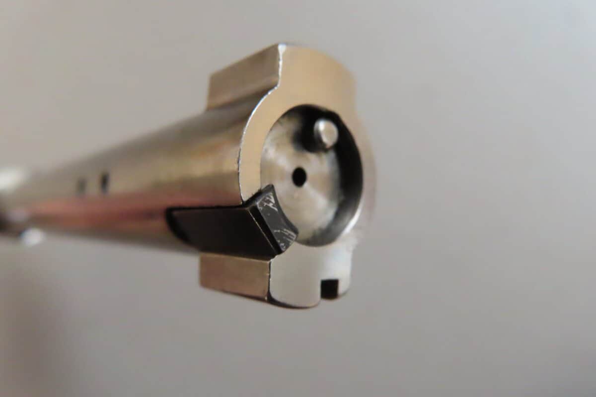 Close-up of a firearm barrel showcasing high-quality ammunition and gun parts.