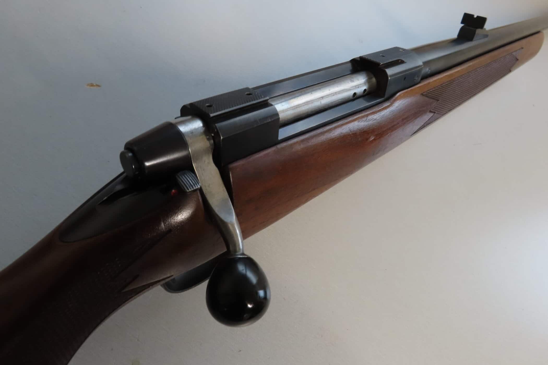Antique bolt-action rifle with wooden stock and metal barrel, suitable for firearm enthusiasts.