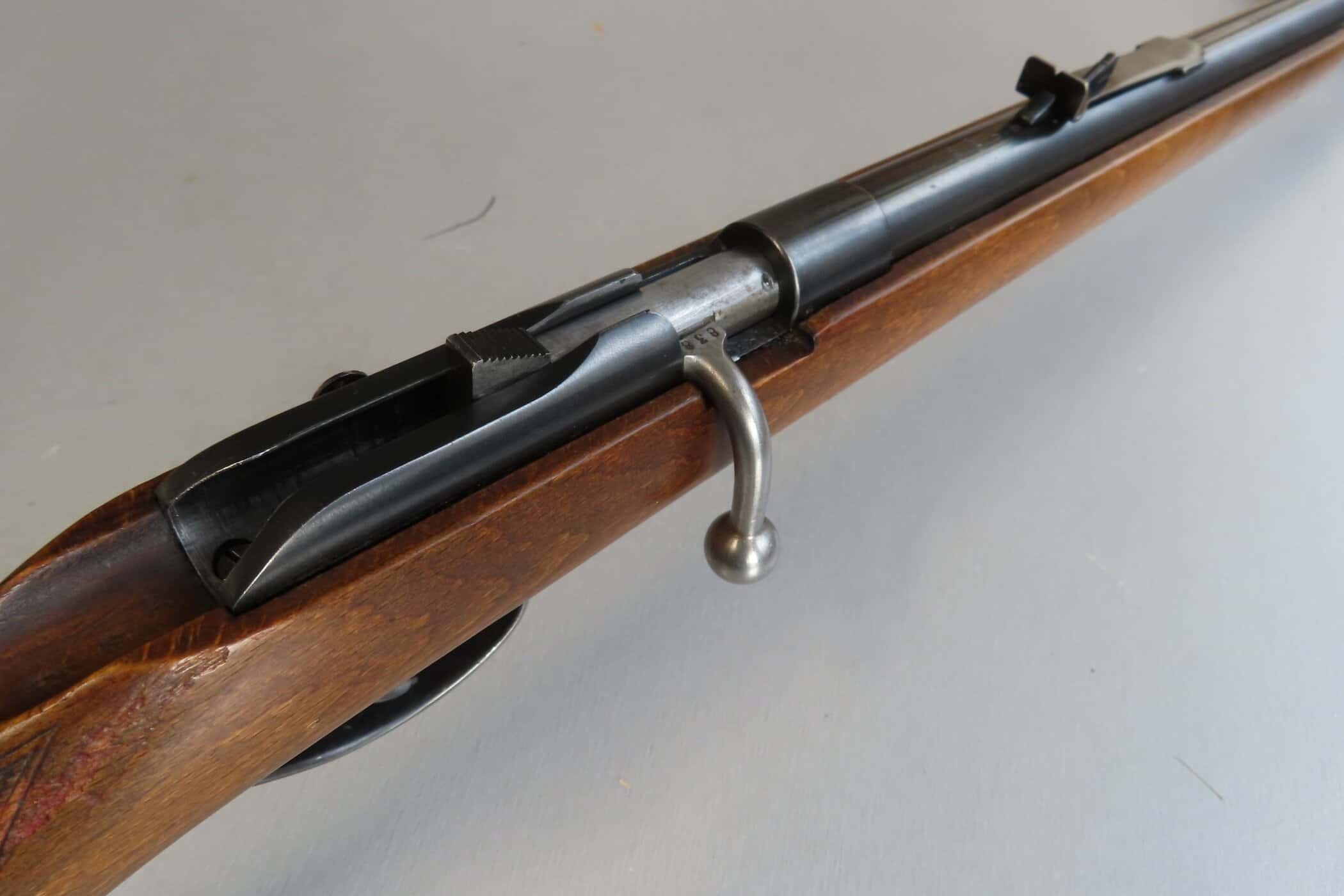 Bolt-action firearm from Colonial Ammunition Company, classic rifle with wooden stock and metal mechanism.