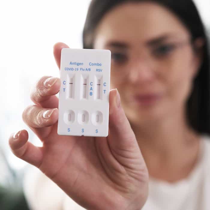 COVID-19 antigen test kit showing results, focus on medical testing and health screening at Calhoun Pharmacy.