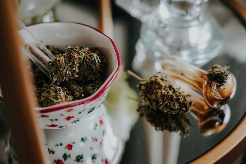 Cannabis buds in bowl and glass pipe