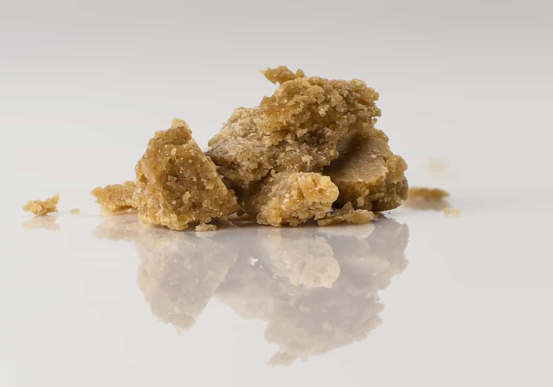 Chunks of brown sugar on white surface