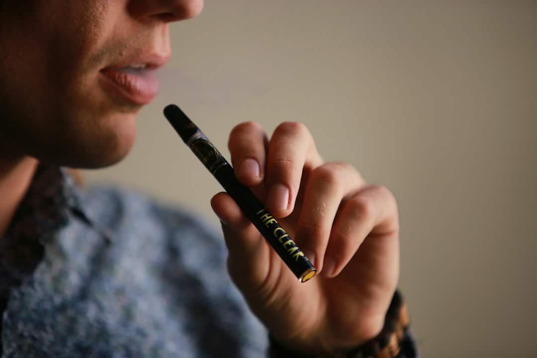 Person holding and using a vape pen