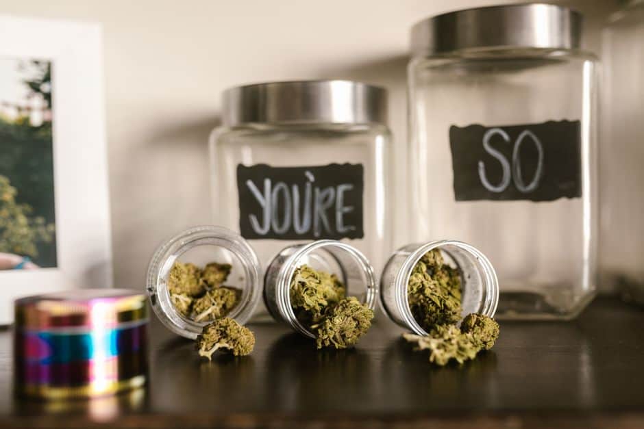 Jars and containers with cannabis buds inside