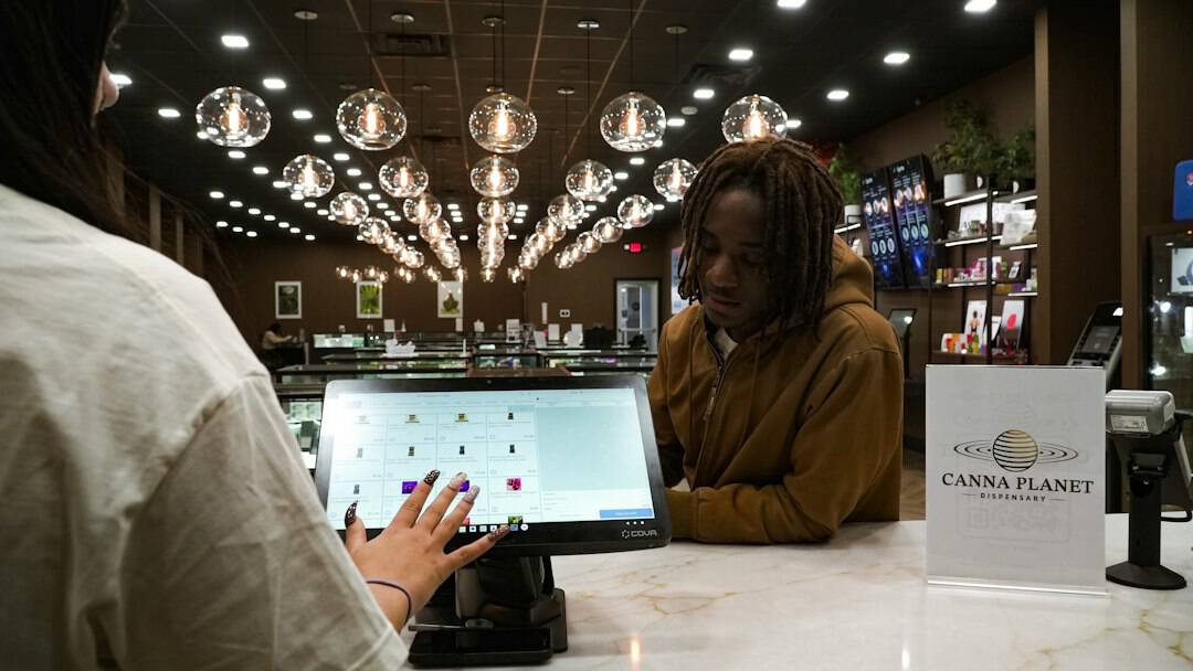 Person ordering at Canna Planet dispensary counter