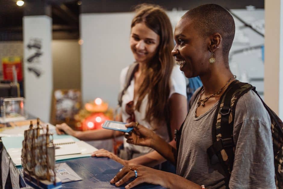 Two women checking in at reception desk