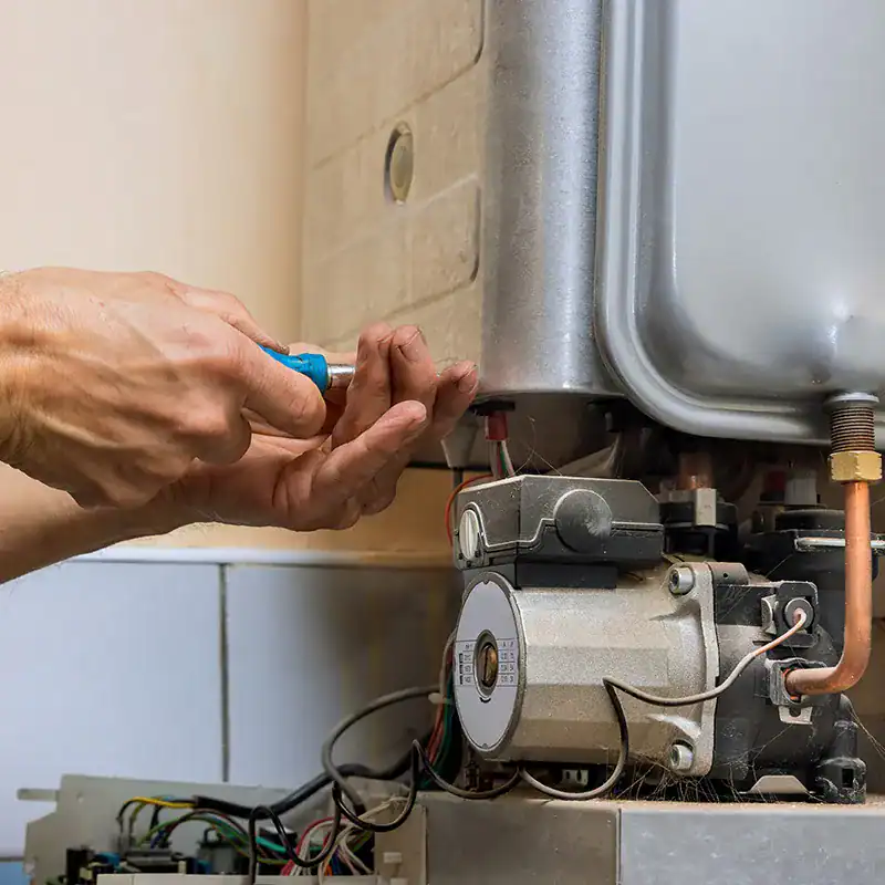 Plumber-Repairing-Tankless-Water-Heater-Internal-Components