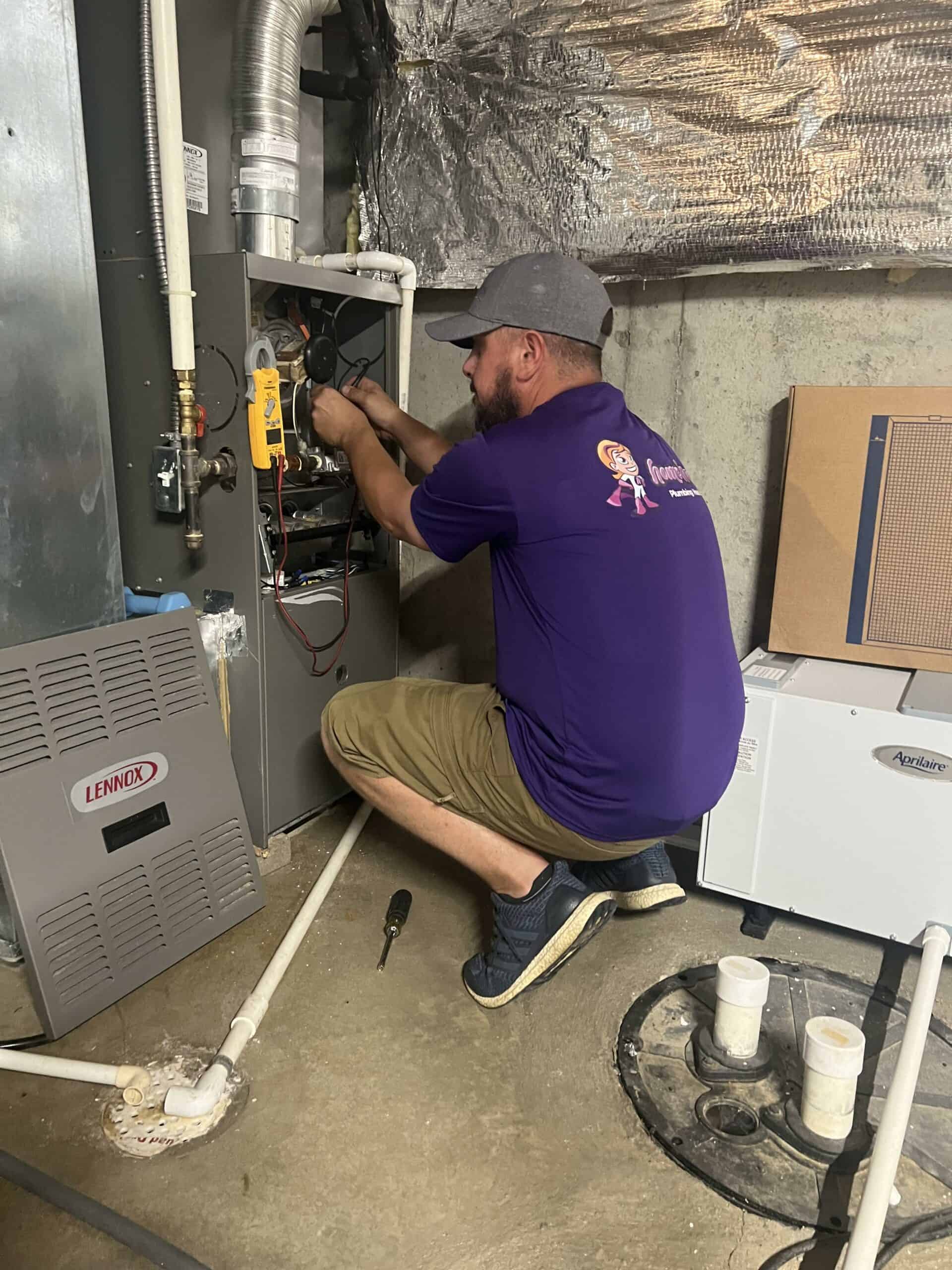 Home Heroes Plumbing Heating & Air - Plumber working on Heating System
