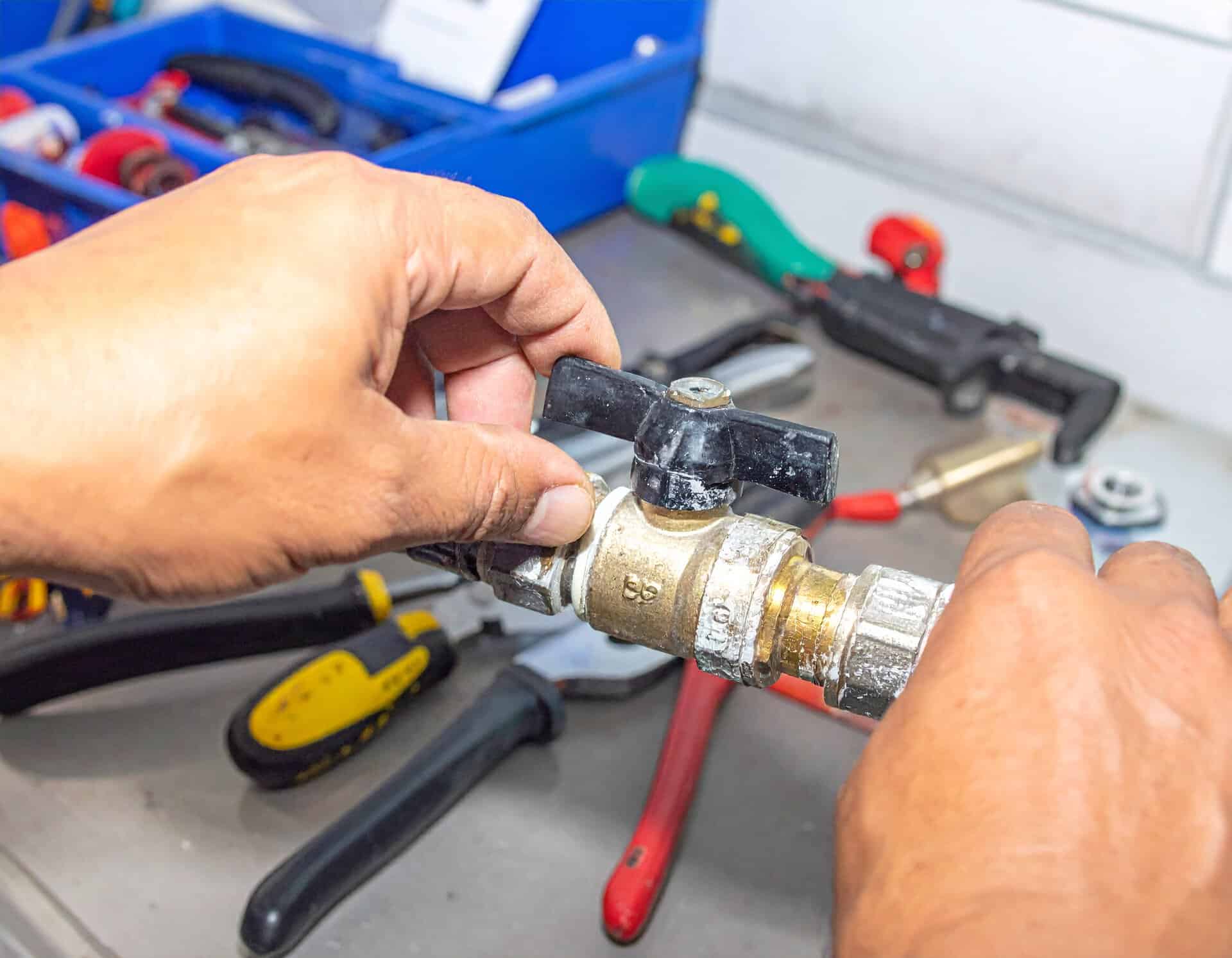 Plumber-Installing-Brass-Ball-Valve-With-Tools