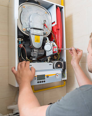 HVAC-Technician-Repairing-Gas-Boiler-Internal-Components