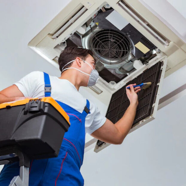HVAC-Technician-Cleaning-Ceiling-Air-Handler-Unit-Filter