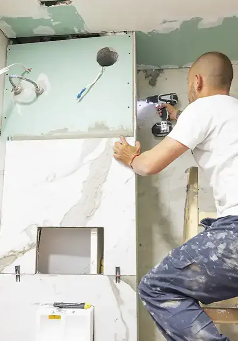 Contractor-Installing-Marble-Tile-In-Bathroom-Remodel