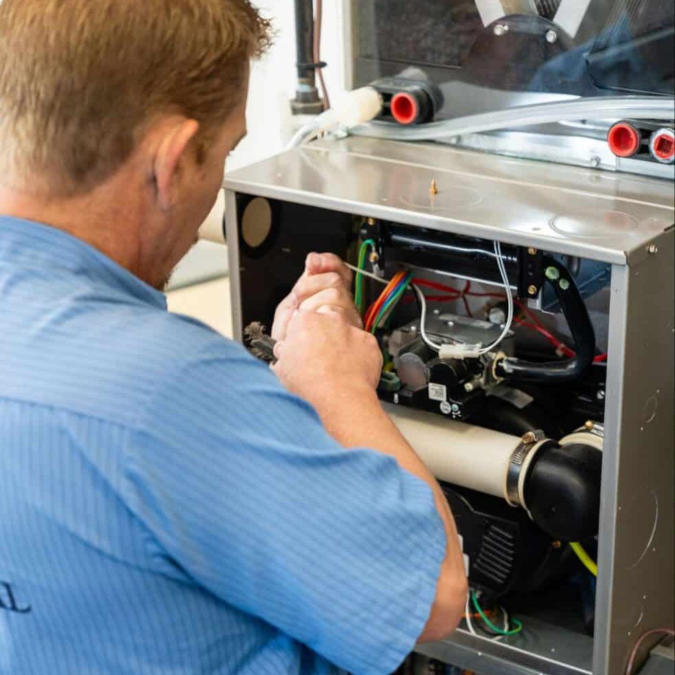 HVAC-Technician-Repairing-Open-Furnace-Internal-Components