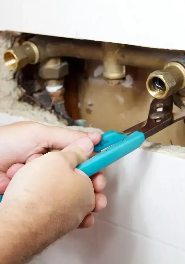 Plumber-Repairing-Brass-Pipe-Fittings-With-Wrench