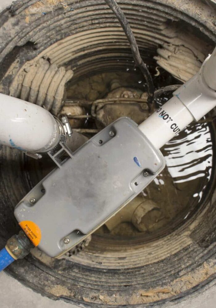 Sump-Pump-With-Discharge-Pipe-In-Basin