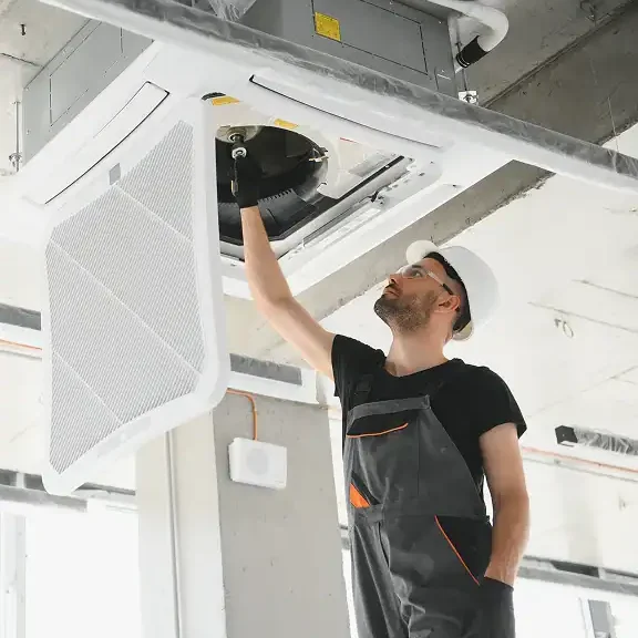 HVAC-Technician-Installing-Ceiling-Cassette-AC-Filter