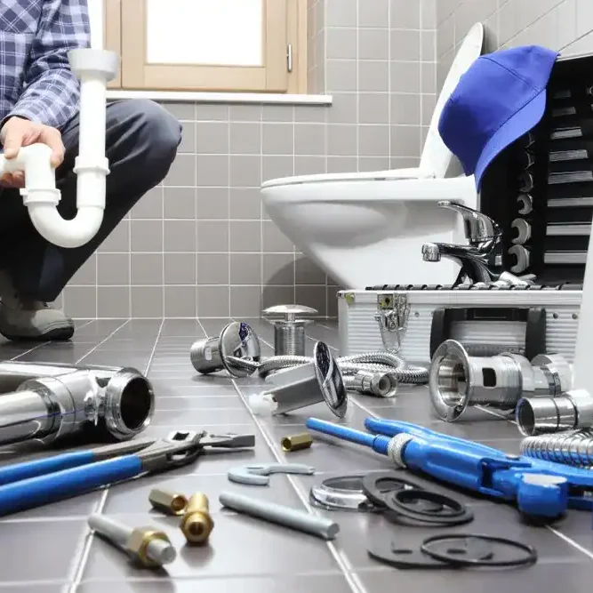 Plumber-With-Tools-And-Bathroom-Plumbing-Parts