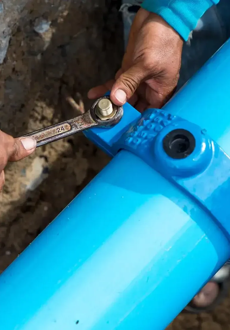 Plumber-Tightening-Underground-Water-Main-Pipe-Connection