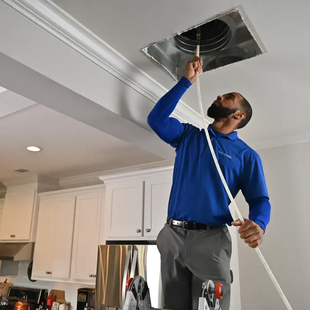 HVAC-Technician-Cleaning-Ceiling-Air-Duct-Vent