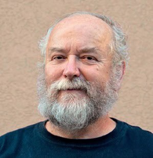 Elderly man with white beard and hair, smiling, promoting cancer immunotherapy.