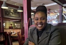 Woman Sitting At Table Having A Cup Of Coffee