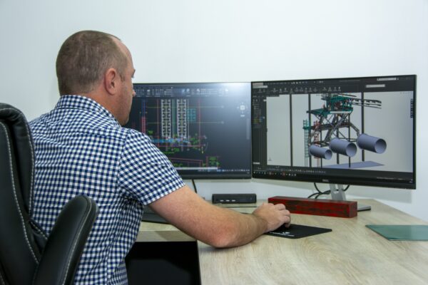 Weba Chute Systems Technical Director Dewald Tintinger inspecting a transfer chute during design review.