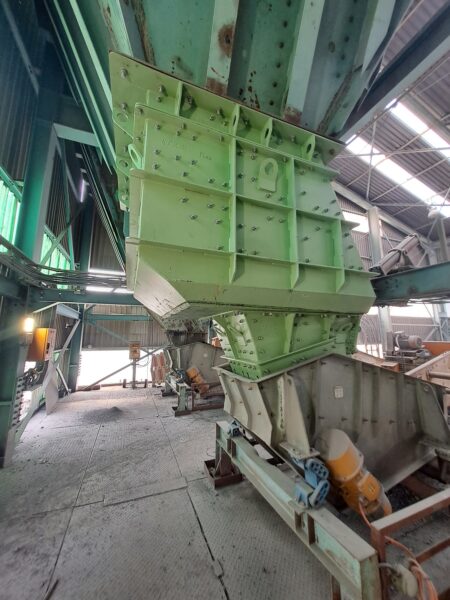 Weba surge-bin discharge chute feeding a low-head screen at a North West platinum mine, engineered for wear life.