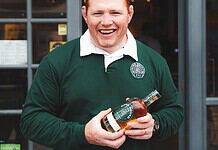 Bomb Squad Beer Steven Kitshoff holding their Bomb Squad Beer Brandy