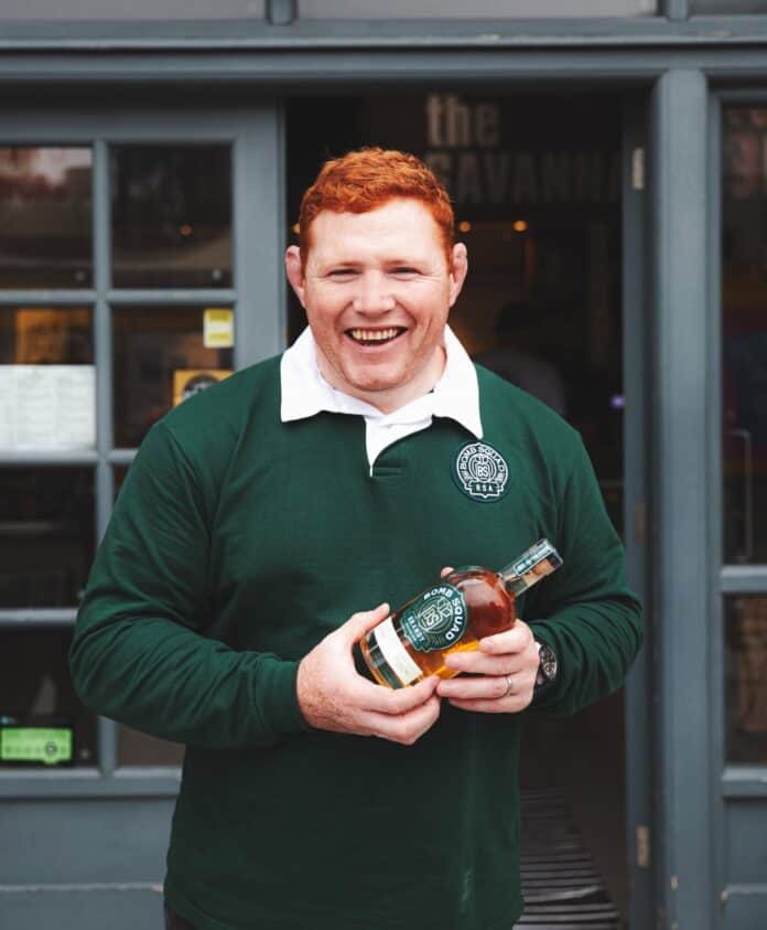 Bomb Squad Beer Steven Kitshoff holding their Bomb Squad Beer Brandy