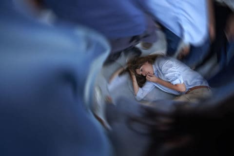 woman lying in bed having a panic attack CBT for Panic