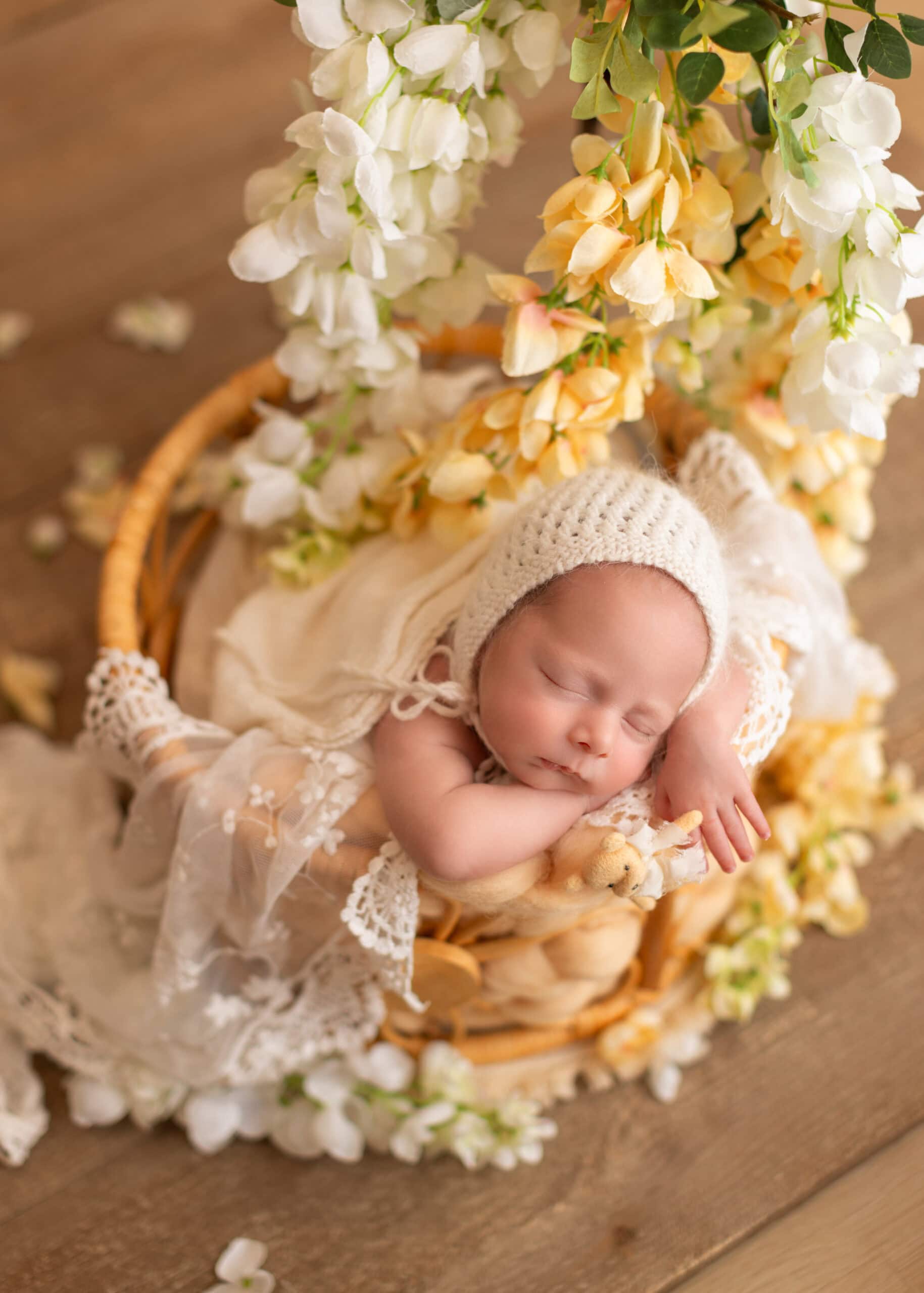 Edmonton newborn photography with baby girl sleep in a basket with full of flowers