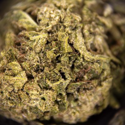 High-quality cannabis bud with frosty trichomes and vibrant green hues.