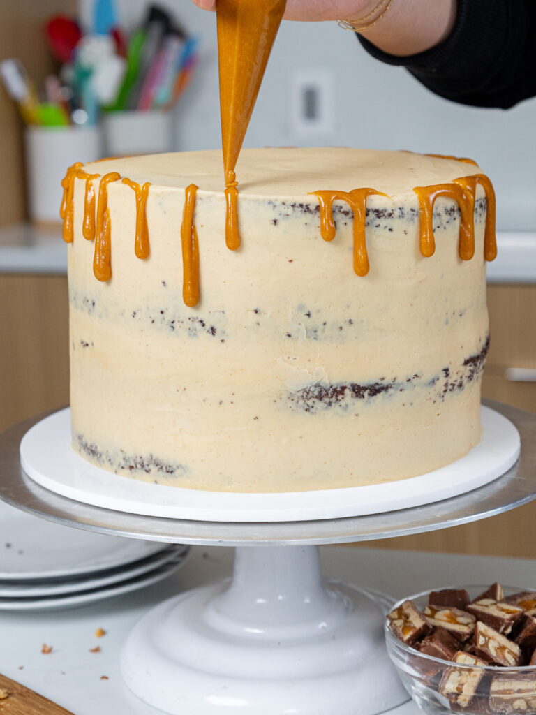 image of a peanut butter cookie being dipped in melted chocolate