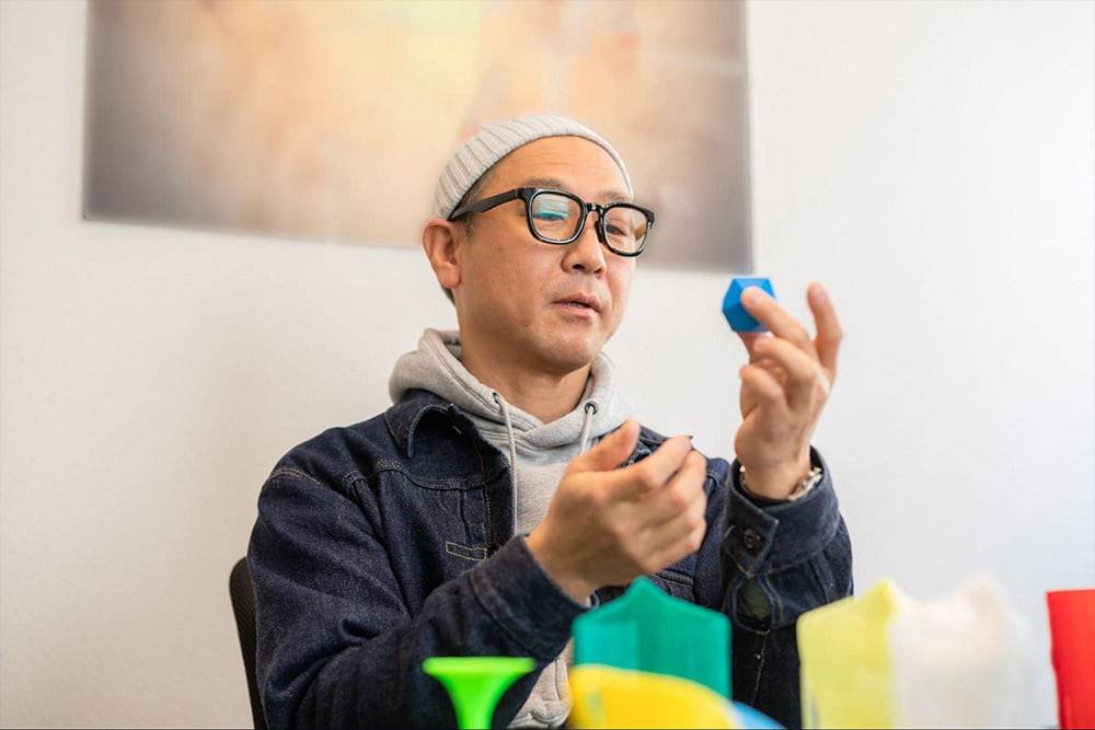 man looking at objects and experimenting