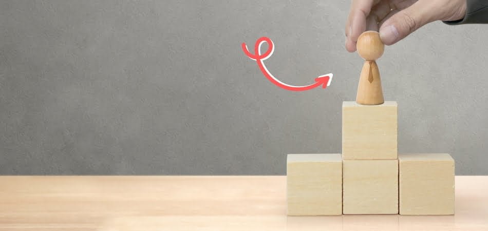 Enhanced personal growth and success strategies with wooden block pyramid representing progress.