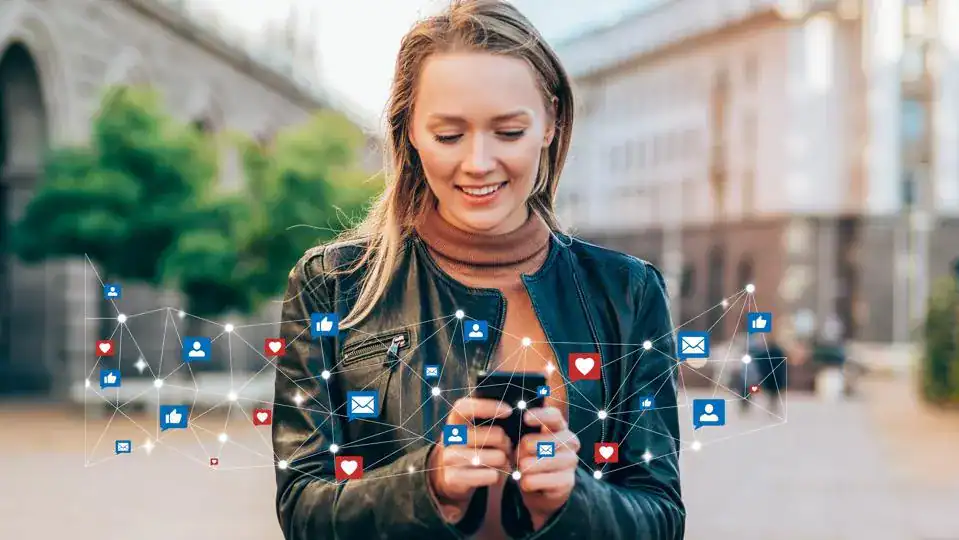 Young woman engaging with social media on smartphone in outdoor urban setting, digital connections and social networking icons overlay, representing online interaction and communication skills.
