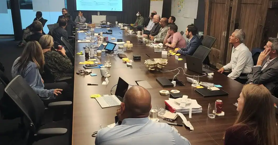 Meeting with diverse professionals in a modern conference room for corporate strategy discussion.