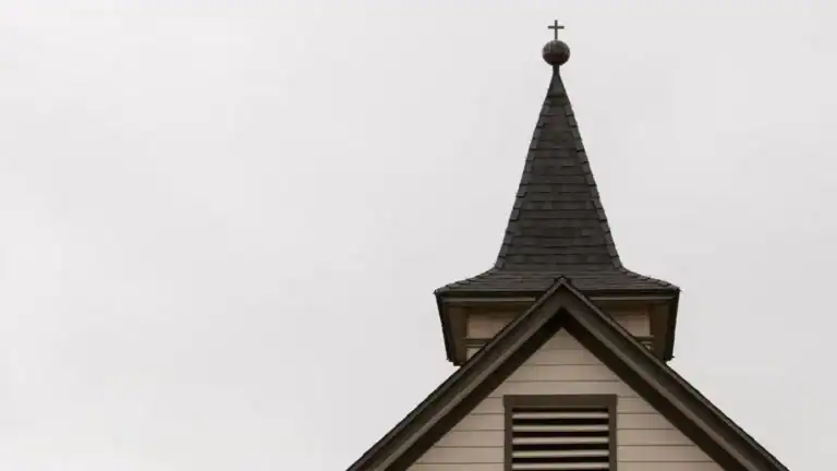 A church steeple with a cross on top