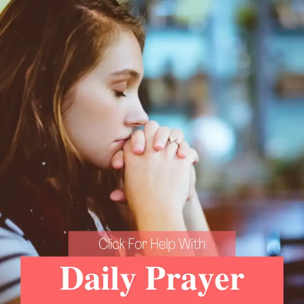 A christian woman praying with her eyes closed and her hands clasped in front of her mouth