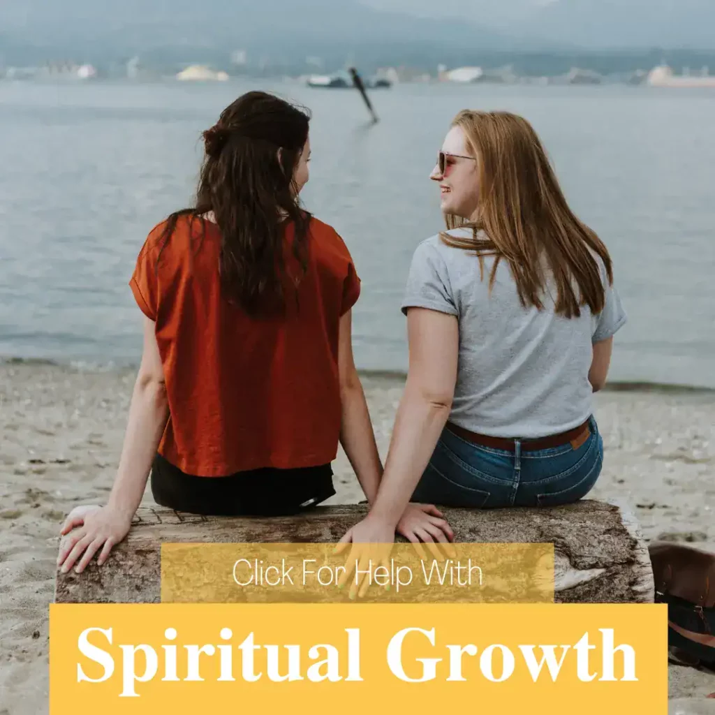 Two christian women sitting on a log by a lake talking to each other