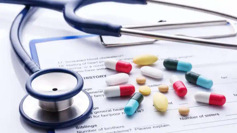 A stethoscope and medication on top of a medical form relating to chronic illness